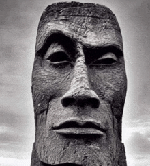 a black and white photo of a statue of a man 's face