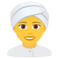 a woman with a white towel wrapped around her head is smiling