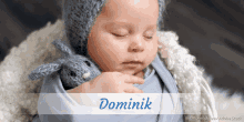 a baby is wrapped in a blue blanket and the name dominik is above him