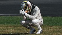 a man wearing a monster helmet kneeling down