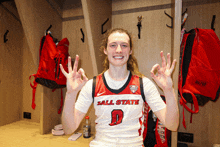 a female basketball player wearing a jersey that says ' all state ' on it