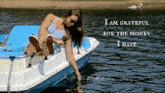 a woman sits on a boat with the words " i am grateful for the money i have " below her