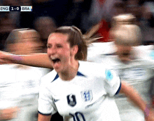 a female soccer player wearing a number 10 jersey is celebrating a goal