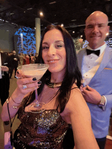 a woman in a sequined top is holding a martini glass