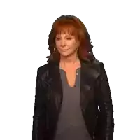 a woman with red hair is wearing a leather jacket and a grey shirt