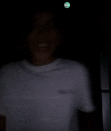 a person in a dark room with a rgx logo on the top