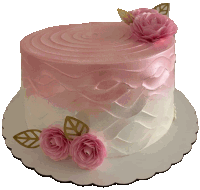 a pink and white cake with roses and leaves on it