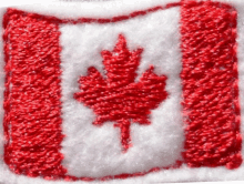 a close up of a canadian flag with a maple leaf on it