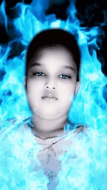 a boy with blue eyes is surrounded by blue flames and smoke