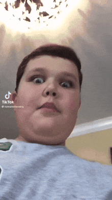 a boy is making a funny face with a tiktok watermark