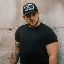 a man wearing a black tekoa baseball cap