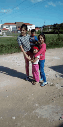 a boy wearing a levi 's shirt is holding a girl