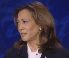 a close up of a woman 's face with a microphone in front of her