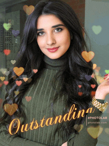 a woman in a green sweater is surrounded by hearts and says outstanding