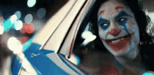 a close up of a clown in a car .