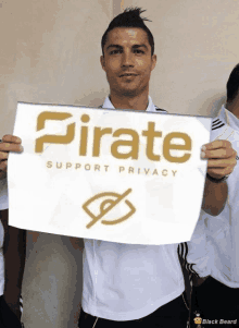 a man in a white shirt holds up a sign that says pirate support privacy