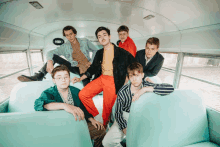 a group of young men sitting on a bus with a sign that says emergency evacuation