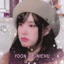 a girl wearing a hat with the name yoon de nichu written on it