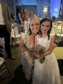 a woman and a little girl pose for a picture