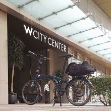 a bicycle is parked in front of a building that says wcity center