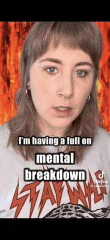 a woman is wearing a shirt that says ' i 'm having a full on mental breakdown ' on it