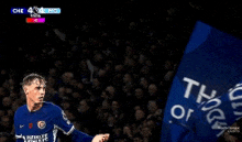 a soccer player with a blue shirt that says ' chelsea ' on it in front of a crowd