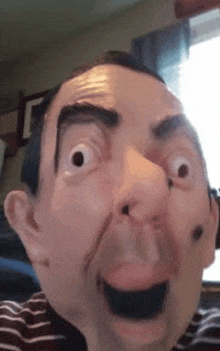 a close up of a man wearing a mr bean mask making a funny face .