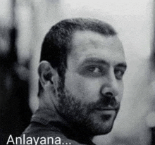 a black and white photo of a man with a beard and the words anlayana written below him .