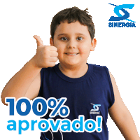 a boy giving a thumbs up in front of a sign that says 100 % approved