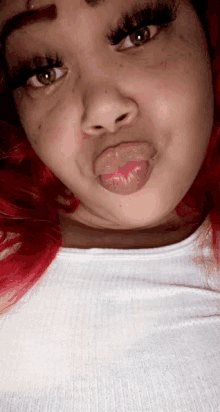 a woman with red hair making a funny face with her tongue out