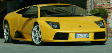 a yellow lamborghini with a license plate that says cr271ka