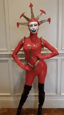 a woman in a clown costume is standing with her hand on her hip