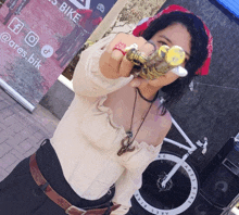 a woman holding a sword in front of a sign that says bike