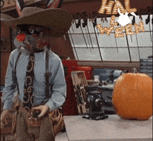 a man wearing a cowboy hat and suspenders stands in front of a pumpkin and a sign that says halloween