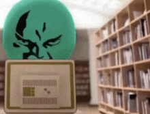 a green ball is sitting on top of a laptop in front of a library