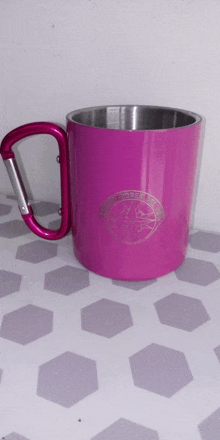 a pink mug with a carabiner on the handle