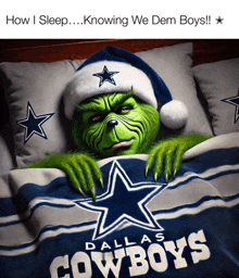 a grinch is laying in a bed with a dallas cowboys shirt on