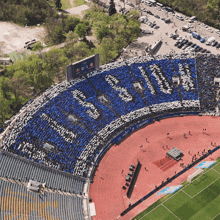 an aerial view of a soccer stadium with a banner that says " is not a crime " on it