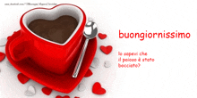 a cup of coffee in a heart shaped cup with a spoon