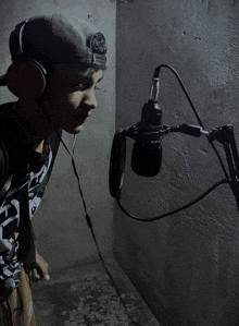 a young man wearing headphones and a hat that says ' snoop dogg ' on it