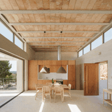 a kitchen with wooden cabinets and a wooden ceiling