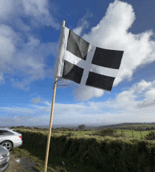 a small black and white flag is flying in the wind