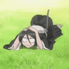 a cartoon character is laying on his back in the grass with his head on his knees .