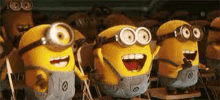 a group of minions are standing next to each other with their mouths open and laughing .