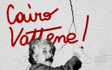 albert einstein is pointing at a crack in the wall with the words cairo vattene written on it