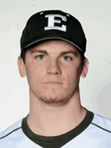 a young man wearing a hat with the letter e on it