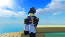 a lego man with a napoleon hat is standing on a ledge overlooking the ocean