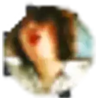 a blurry picture of a woman 's face with a red spot on her nose