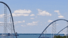 a roller coaster with a blue sky in the background