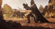 a man kneeling down with a gun in his hand